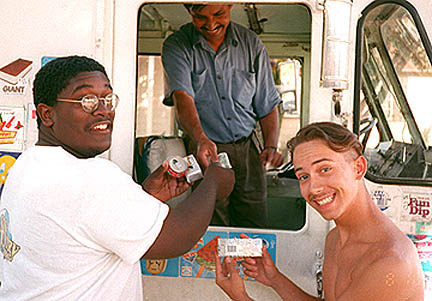Missionaries Willie, left, and Micah, right, cool off with some ice cream.
